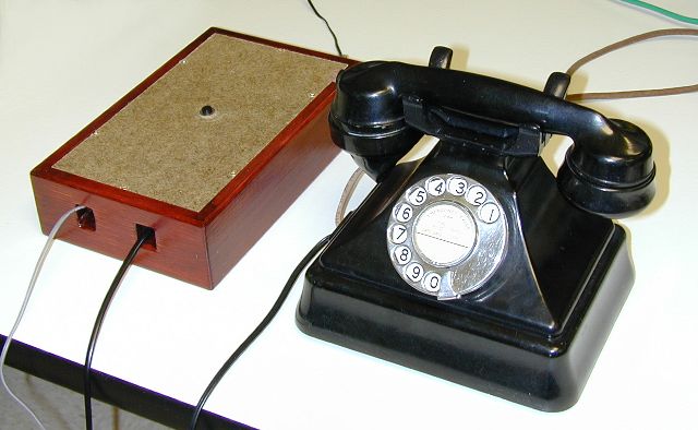 the phone and converter on the bench